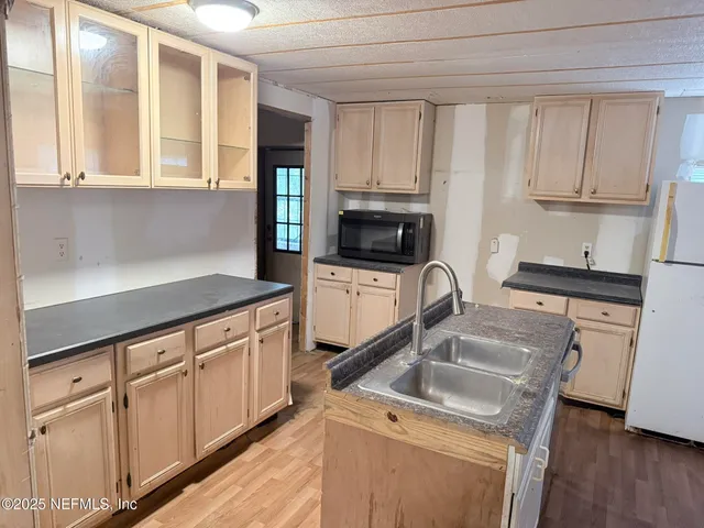 a kitchen with stainless steel appliances granite countertop a sink stove and cabinets