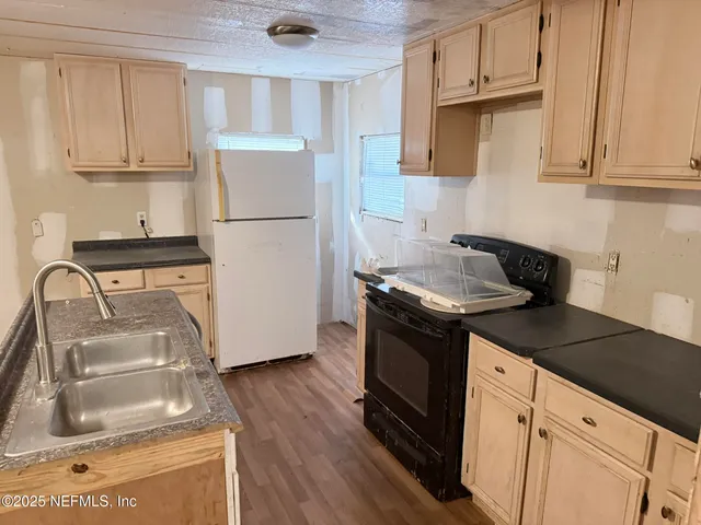 a kitchen with appliances cabinets and a counter top space