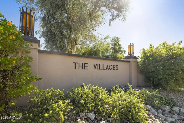 a sign broad in front of flowers