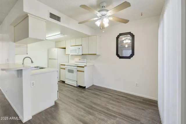 a kitchen with granite countertop a sink stainless steel appliances and cabinets