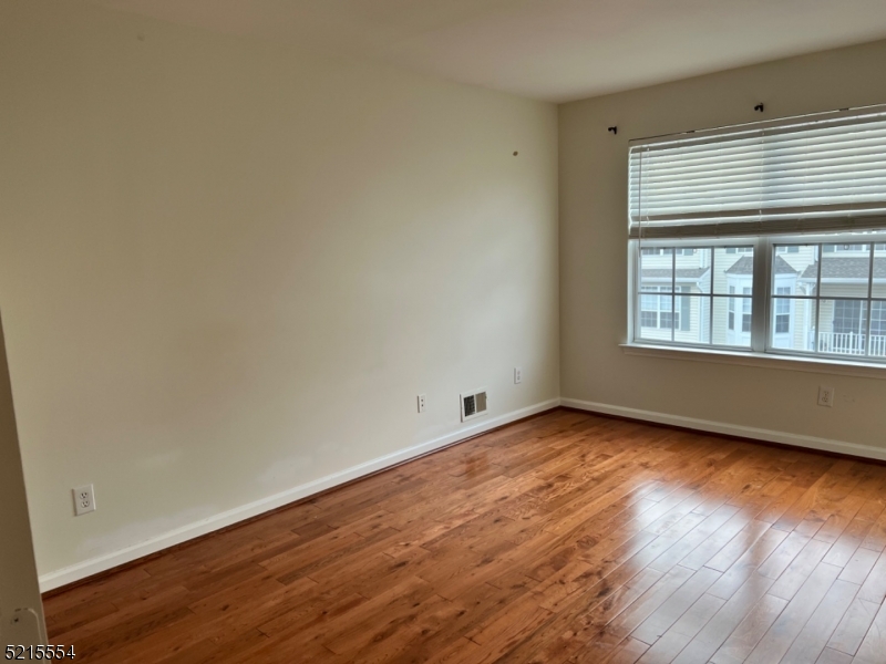 8 Worthington Terrace Flemington, NJ 08822 - Photo 12 of 18 an empty room with wooden floor and windows