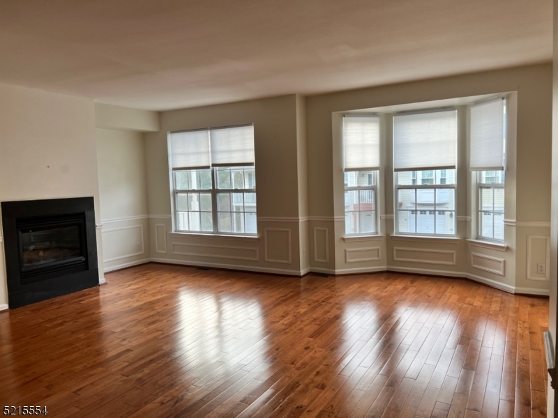 8 Worthington Terrace Flemington, NJ 08822 - Photo 2 of 18 a view of an empty room with wooden floor and a window