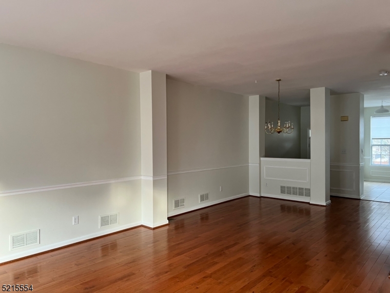 8 Worthington Terrace Flemington, NJ 08822 - Photo 5 of 18 an empty room with wooden floor and windows