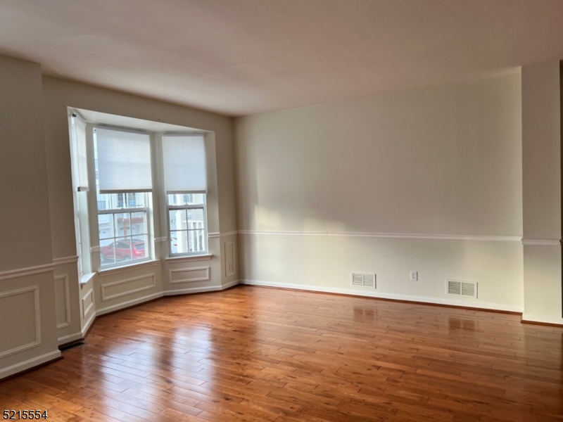 8 Worthington Terrace Flemington, NJ 08822 - Photo 6 of 18 an empty room with wooden floor and windows