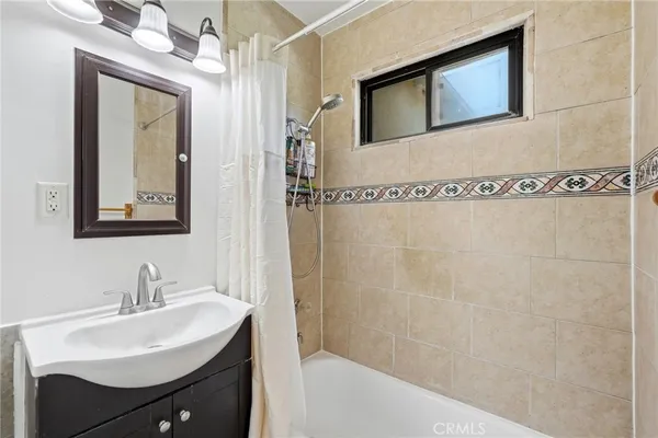 a bathroom with a sink a mirror and a shower