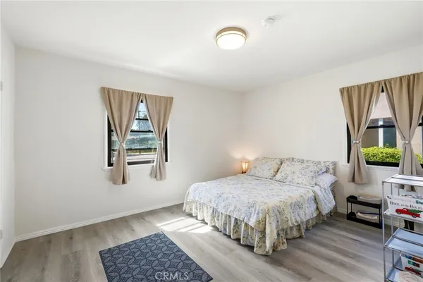 a bedroom with a bed table and window