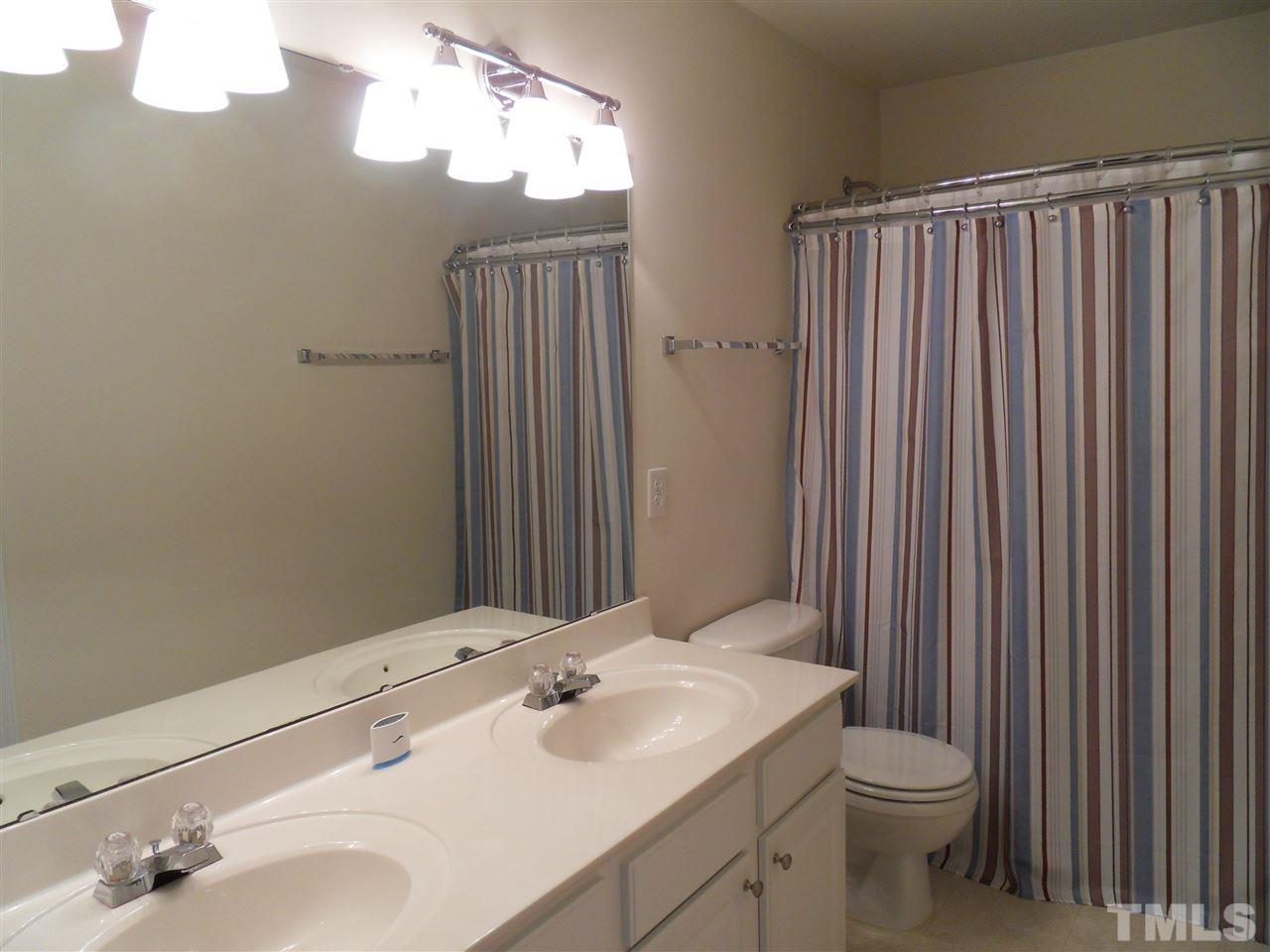 5327 Griffith Park Road Raleigh, NC 27613 - Photo 11 of 25 a bathroom with a sink vanity mirror and toilet