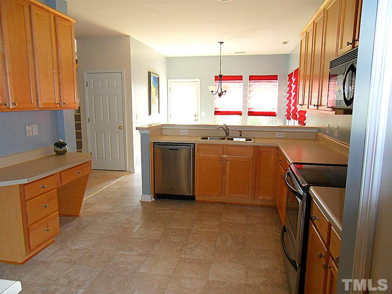 5327 Griffith Park Road Raleigh, NC 27613 - Photo 17 of 25 a kitchen with stainless steel appliances granite countertop a sink and a refrigerator