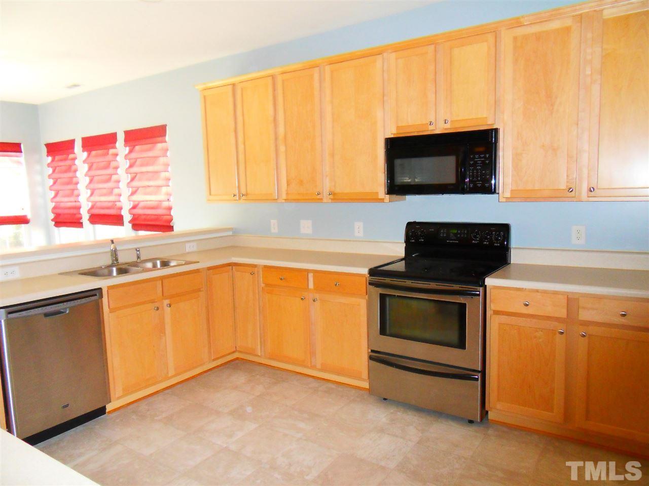 5327 Griffith Park Road Raleigh, NC 27613 - Photo 3 of 25 a kitchen with stainless steel appliances a stove microwave and sink
