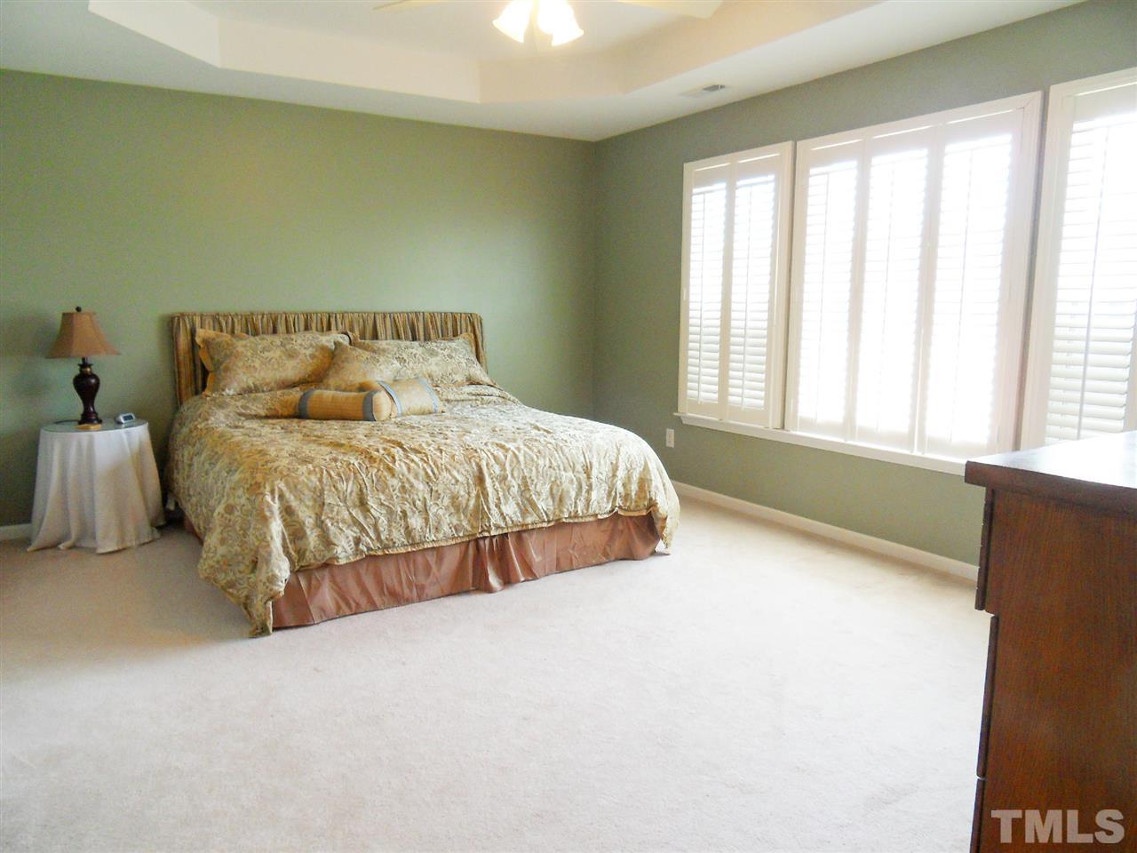 5327 Griffith Park Road Raleigh, NC 27613 - Photo 6 of 25 a large bed sitting in a bedroom next to a window
