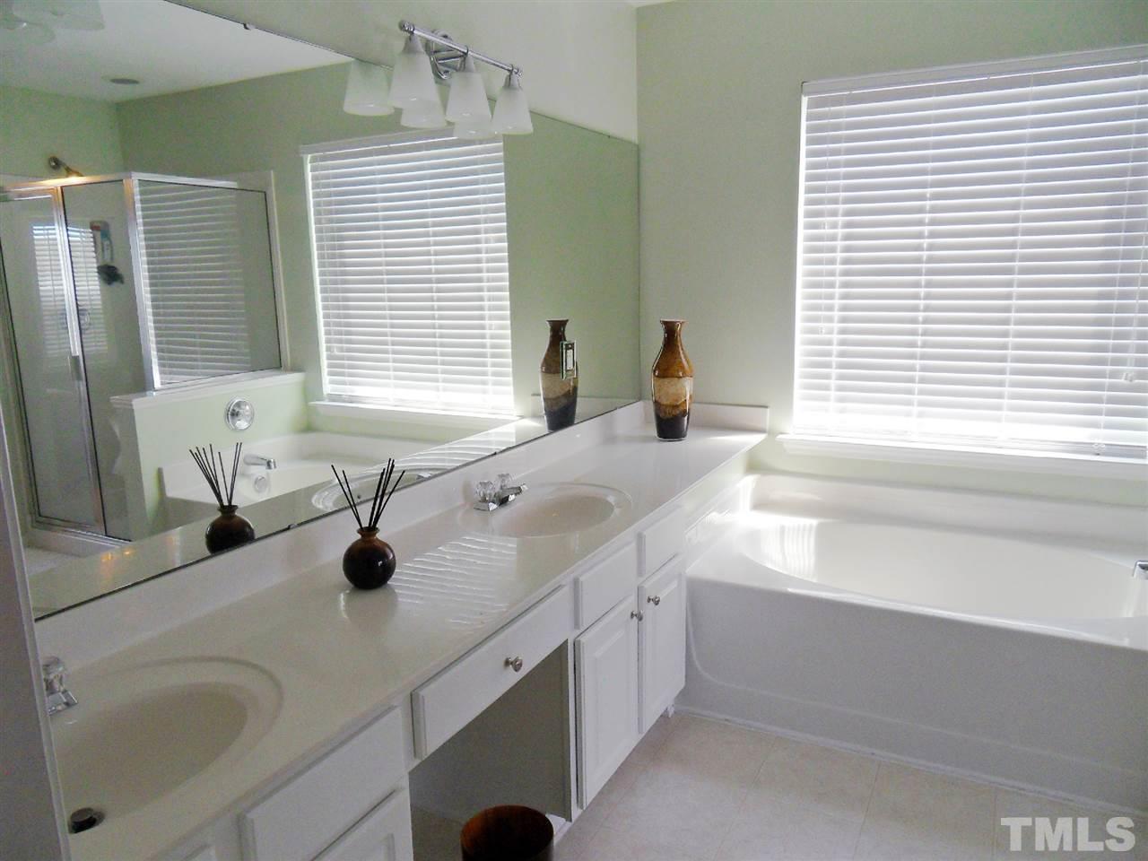 5327 Griffith Park Road Raleigh, NC 27613 - Photo 7 of 25 a bathroom with a sink double vanity and a bathtub