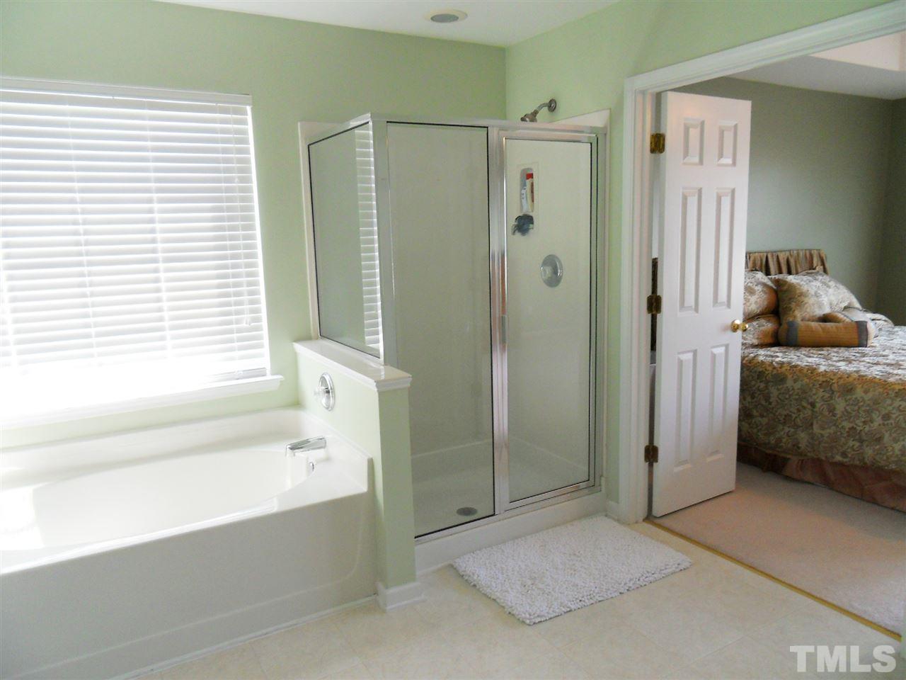 5327 Griffith Park Road Raleigh, NC 27613 - Photo 8 of 25 a en suite bathroom with a tub shower and a sink