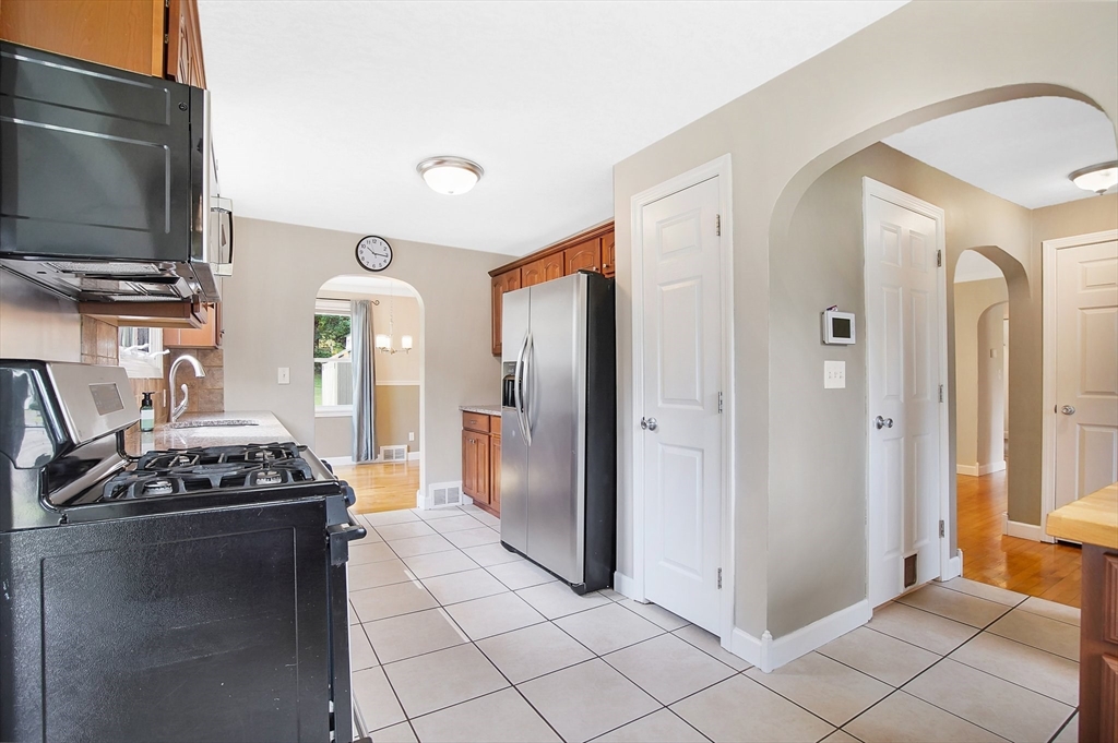 65 Bartels Street Springfield, MA 01128 - Photo 12 of 42 a kitchen with stainless steel appliances granite countertop a refrigerator and a stove top oven