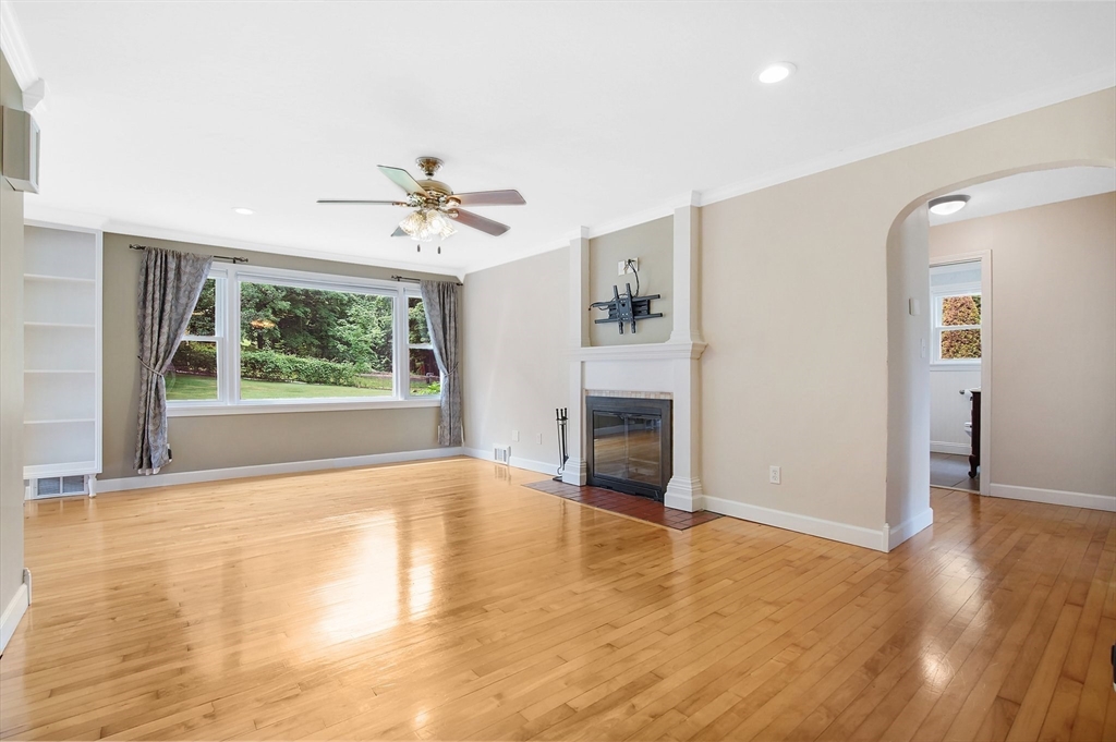 65 Bartels Street Springfield, MA 01128 - Photo 14 of 42 wooden floor fireplace and windows in an empty room
