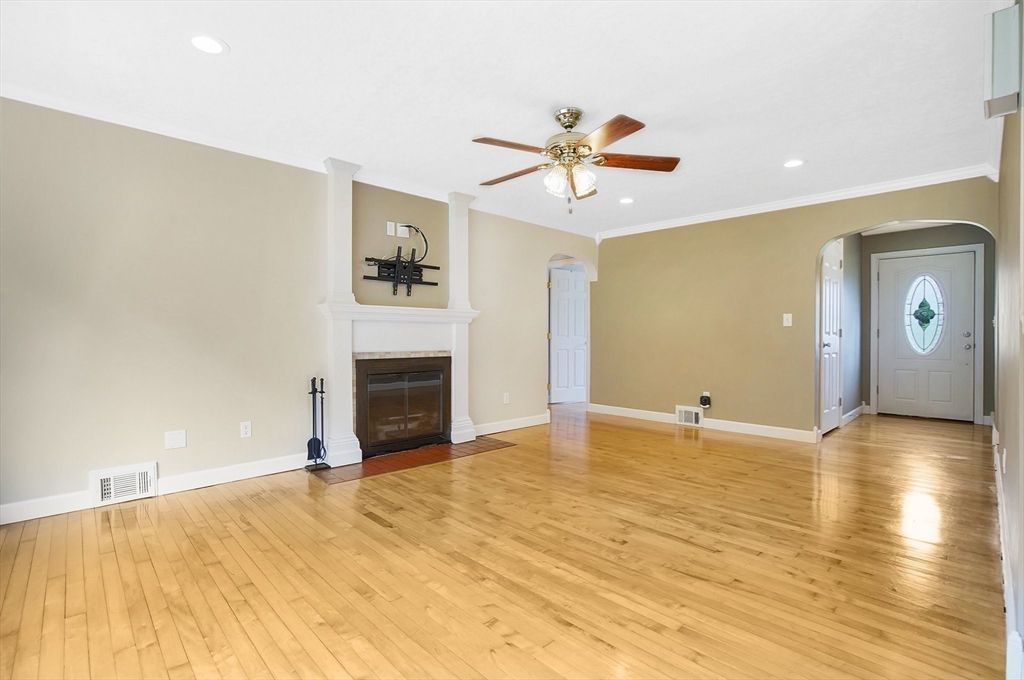 65 Bartels Street Springfield, MA 01128 - Photo 18 of 42 a view of a big room with wooden floor and chandelier