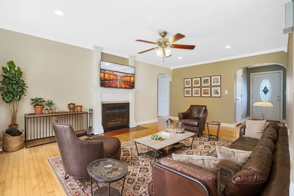 65 Bartels Street Springfield, MA 01128 - Photo 19 of 42 a living room with furniture a fireplace and a flat screen tv