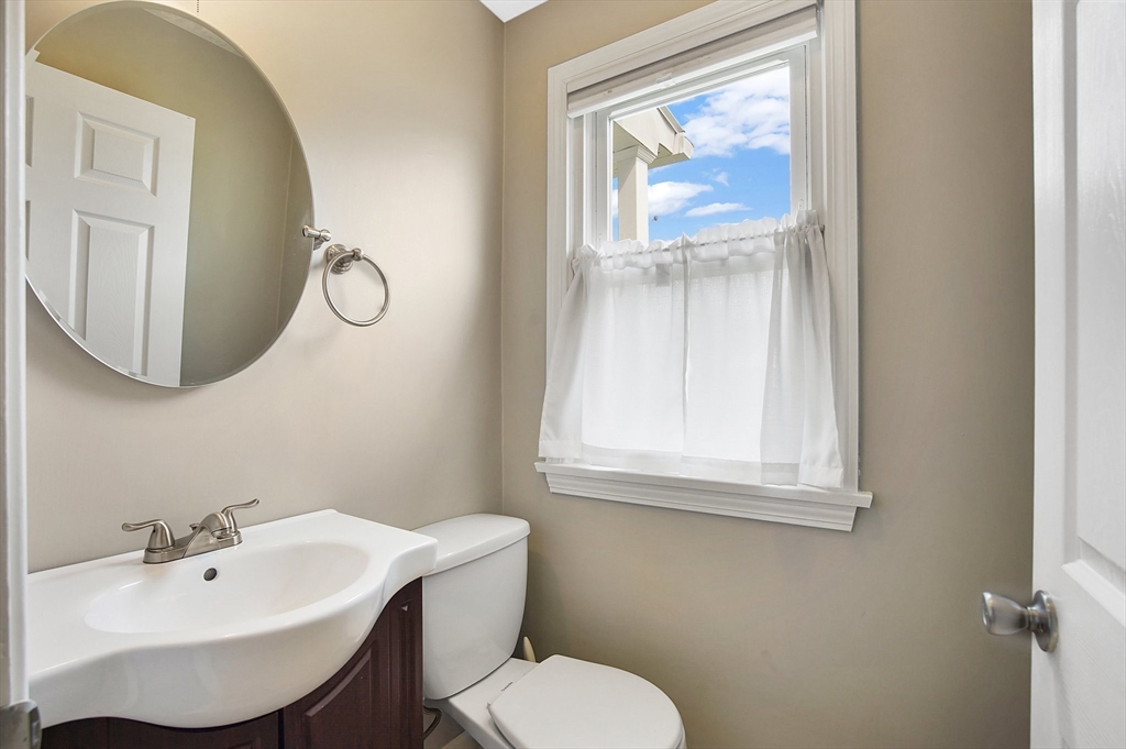 65 Bartels Street Springfield, MA 01128 - Photo 25 of 42 a bathroom with a sink and mirror with toilet