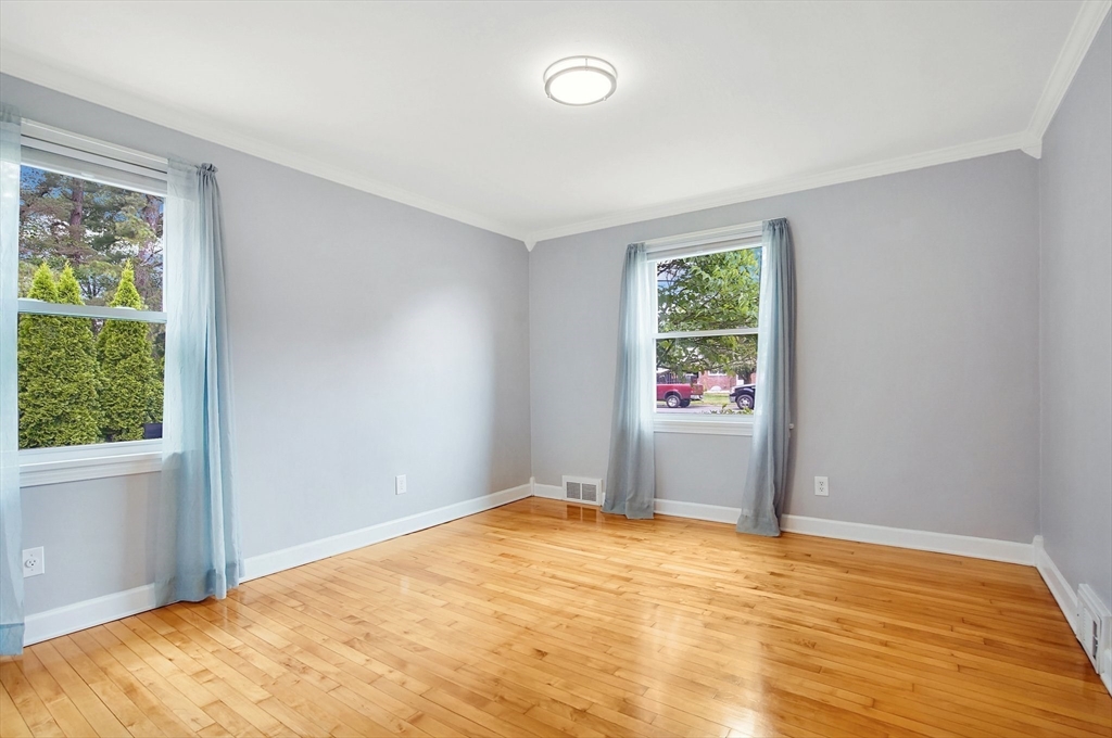 65 Bartels Street Springfield, MA 01128 - Photo 28 of 42 a view of an empty room with wooden floor and a window