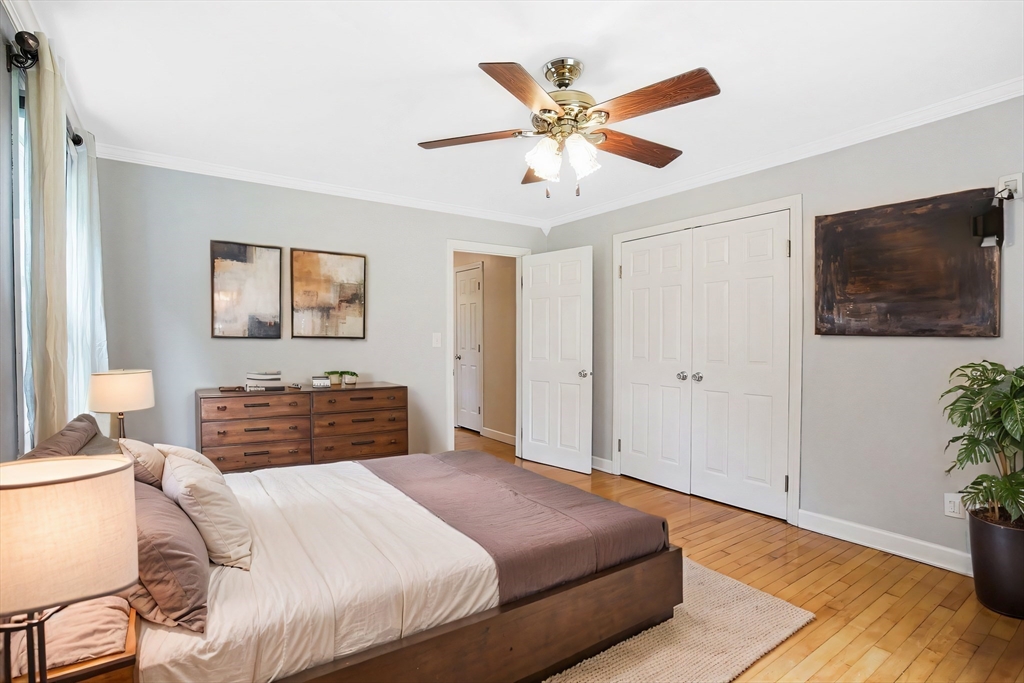 65 Bartels Street Springfield, MA 01128 - Photo 34 of 42 a bedroom with a large bed and a chandelier