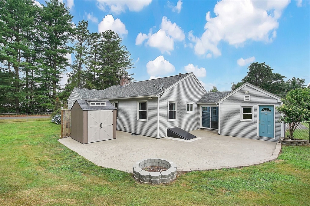 65 Bartels Street Springfield, MA 01128 - Photo 39 of 42 a white house with a big yard and large trees