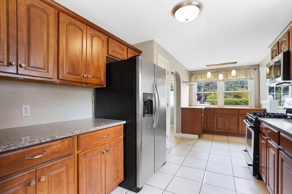 65 Bartels Street Springfield, MA 01128 - Photo 7 of 42 a kitchen with stainless steel appliances granite countertop a refrigerator and a sink