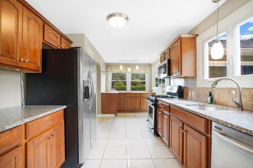 65 Bartels Street Springfield, MA 01128 - Photo 9 of 42 a kitchen with stainless steel appliances granite countertop a sink and a stove