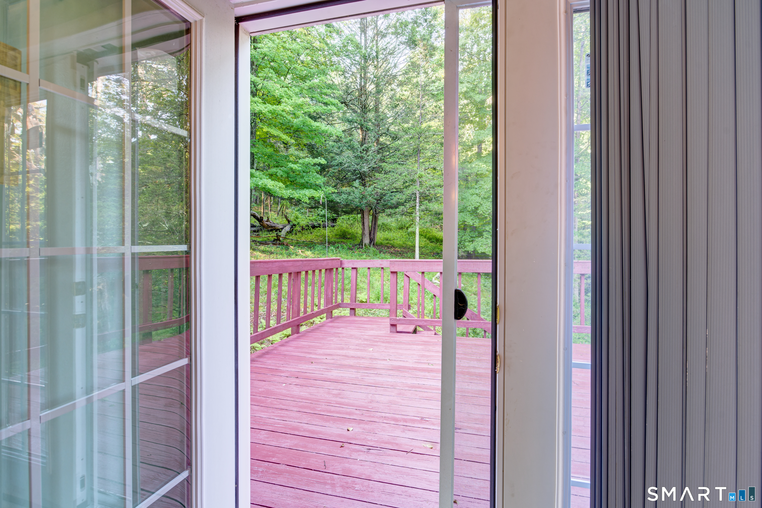 1634 Stafford Road Mansfield, CT 06268 - Photo 30 of 40 Looking out upstairs bedroom French Doors to Side Deck and yard