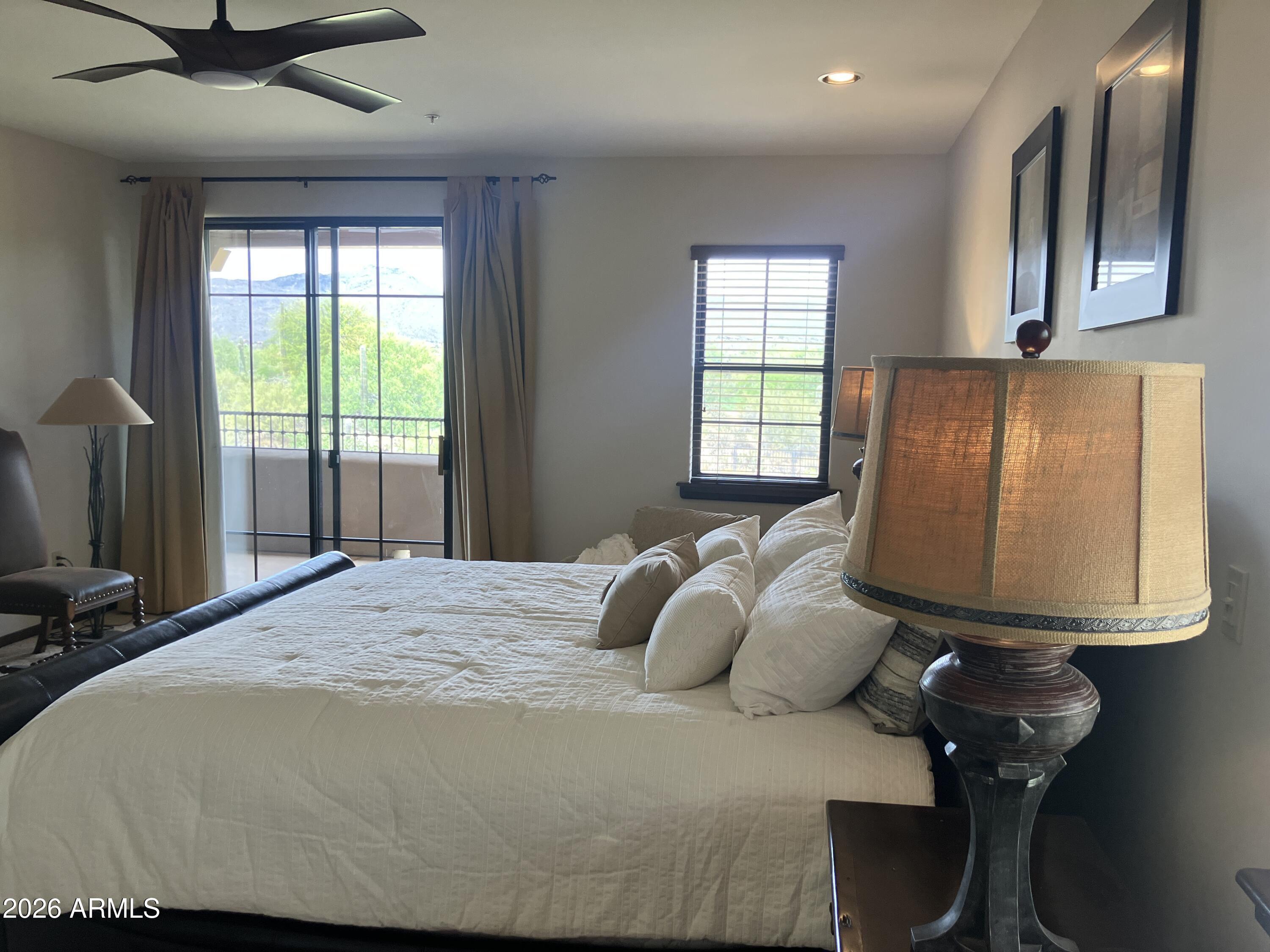 36601 North Mule Train Road, Unit 13D Carefree, AZ 85377 - Photo 15 of 51 a bedroom with a bed and wooden floor
