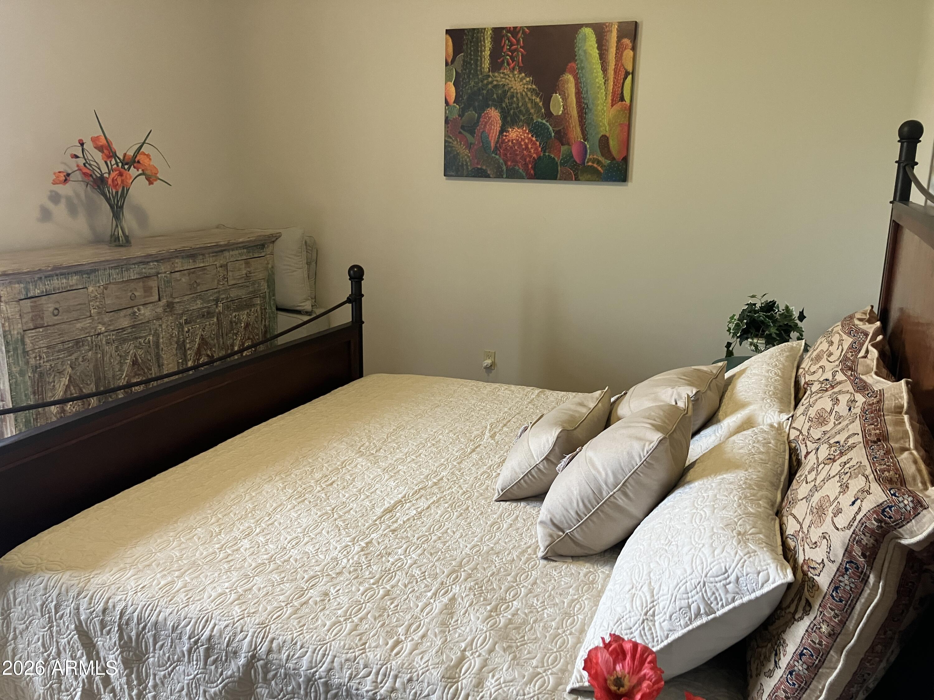 36601 North Mule Train Road, Unit 13D Carefree, AZ 85377 - Photo 24 of 51 a bedroom with a bed and a chandelier