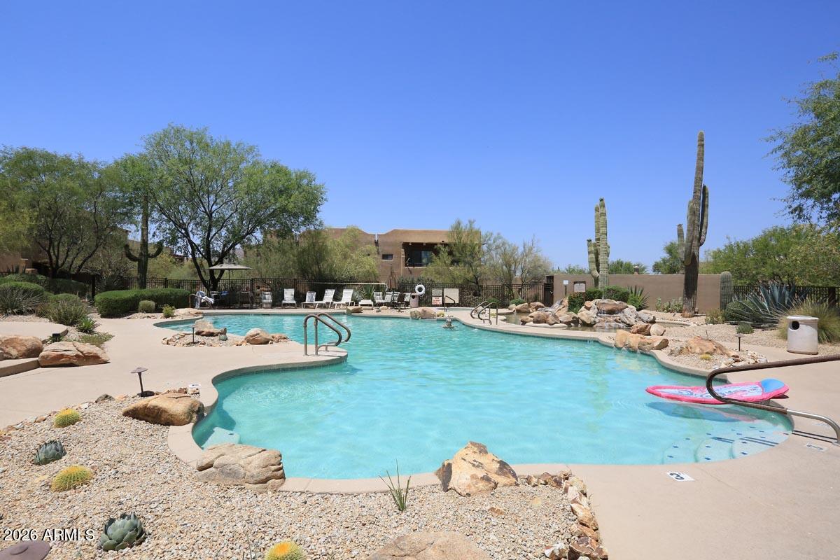 36601 North Mule Train Road, Unit 13D Carefree, AZ 85377 - Photo 49 of 51 a view of a lake with beach and palm trees