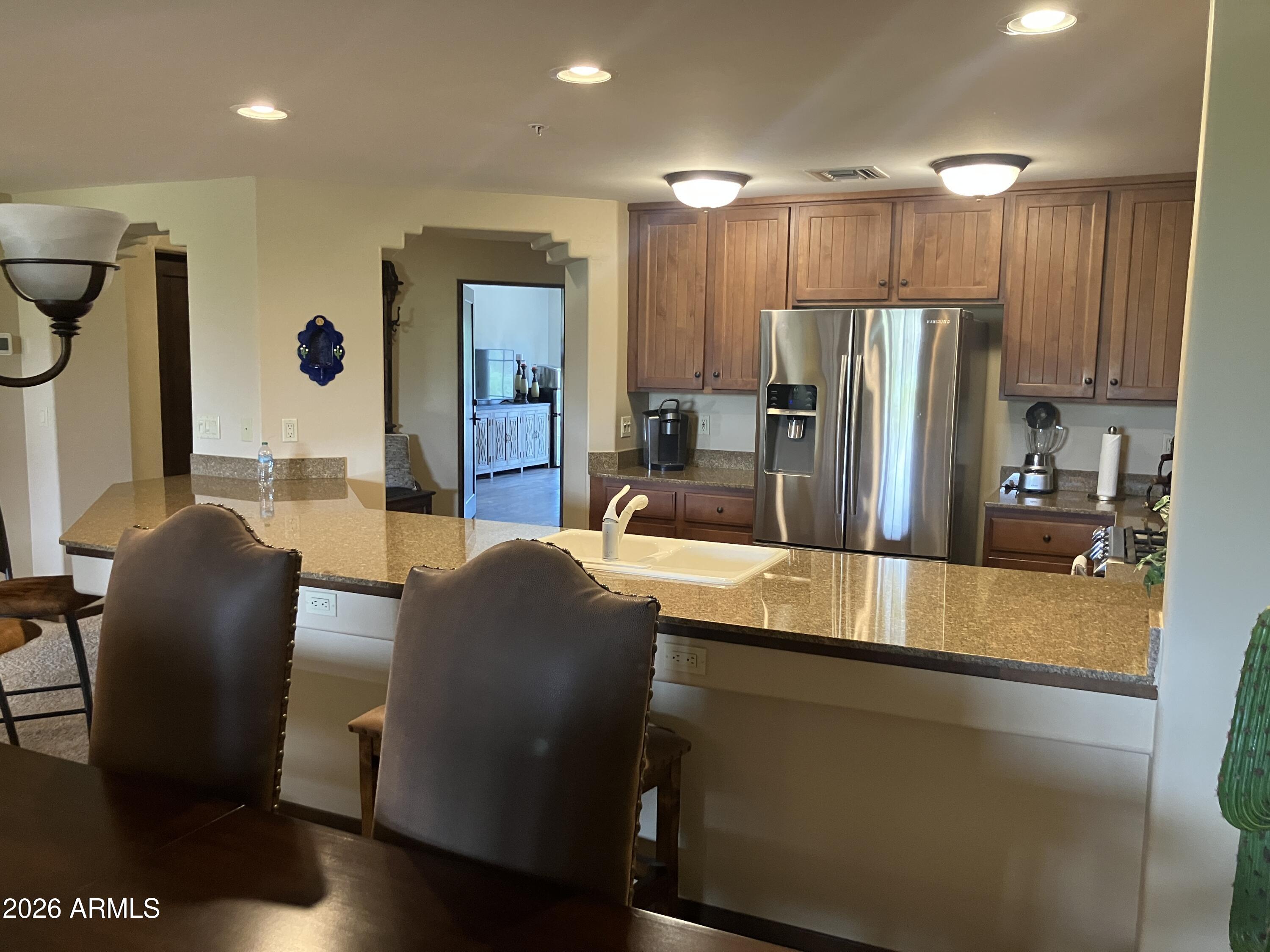 36601 North Mule Train Road, Unit 13D Carefree, AZ 85377 - Photo 7 of 51 a kitchen with stainless steel appliances granite countertop a refrigerator and a sink