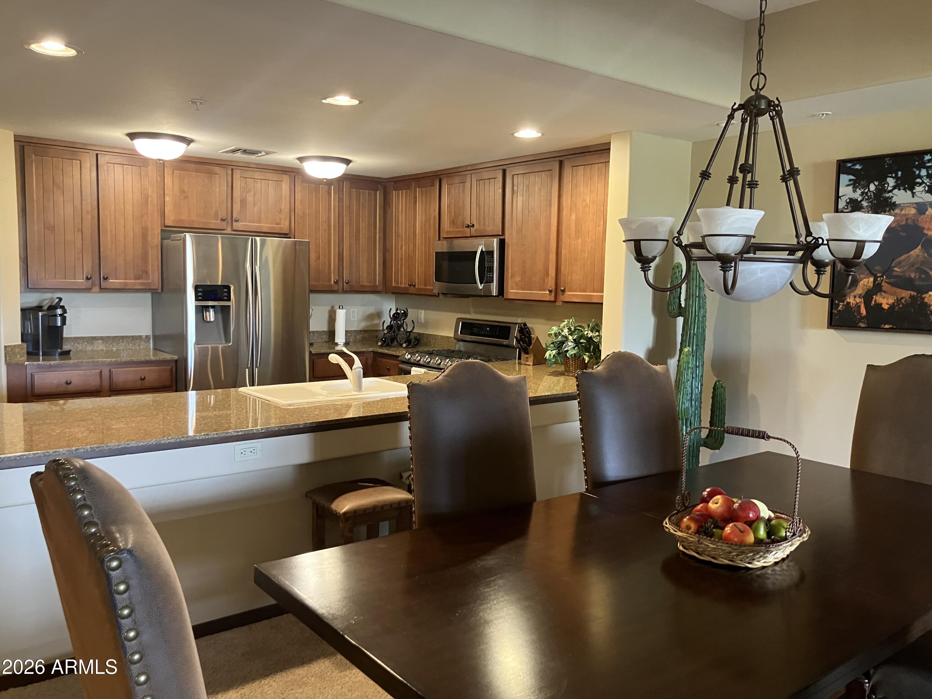 36601 North Mule Train Road, Unit 13D Carefree, AZ 85377 - Photo 8 of 51 a kitchen with stainless steel appliances granite countertop a sink refrigerator and cabinets