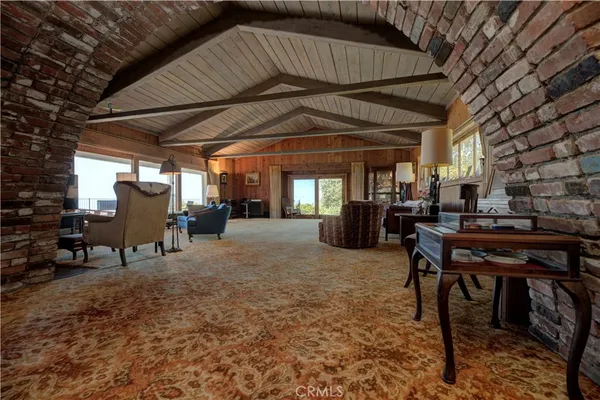 a living room with furniture and a floor to ceiling window
