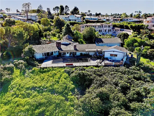 an aerial view of a house with a swimming pool and garden