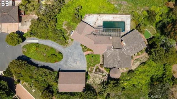 a view of a house with a yard and sitting area