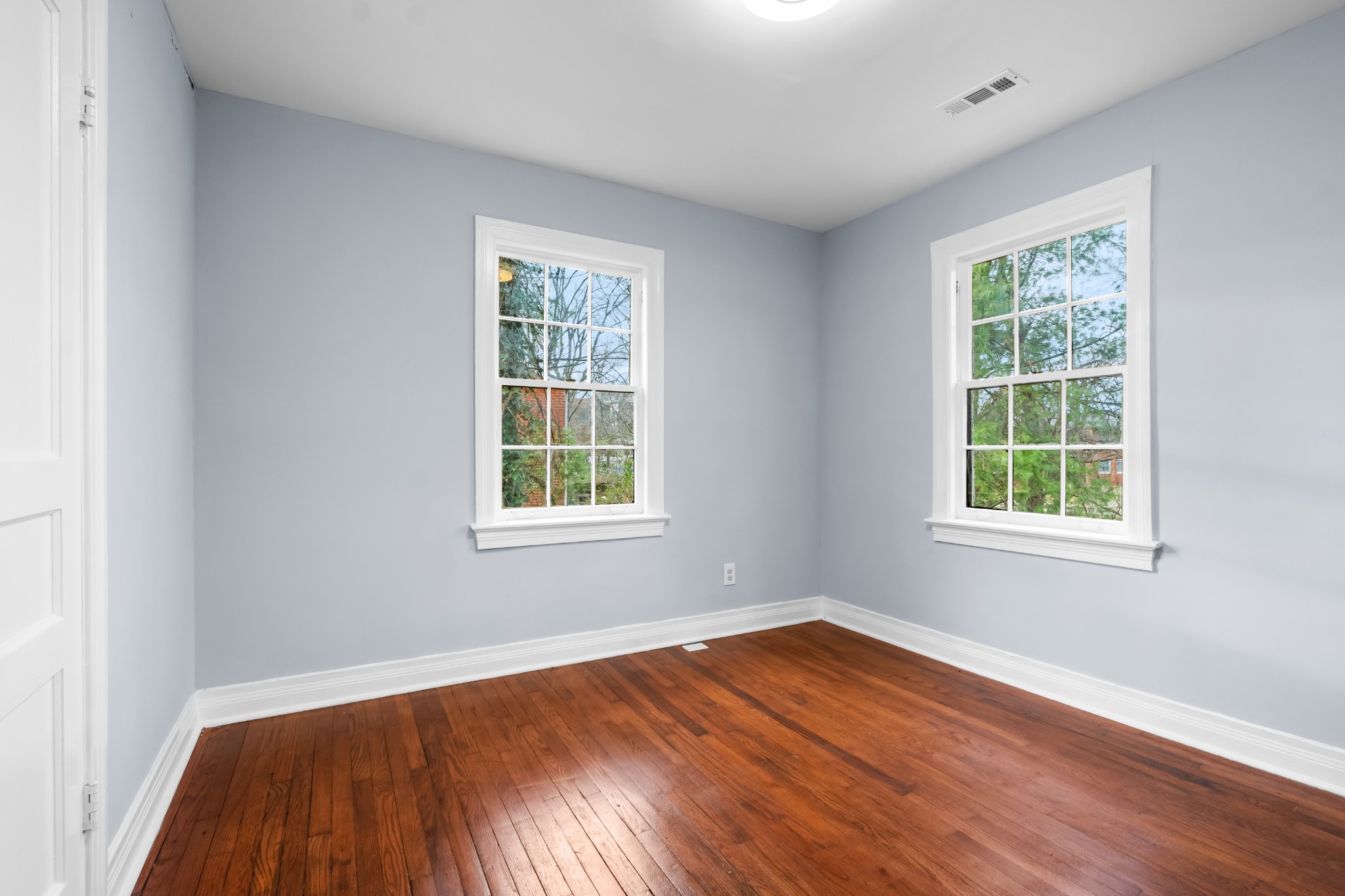 1815 Ragland Avenue Murfreesboro, TN 37130 - Photo 10 of 15 an empty room with wooden floor and windows