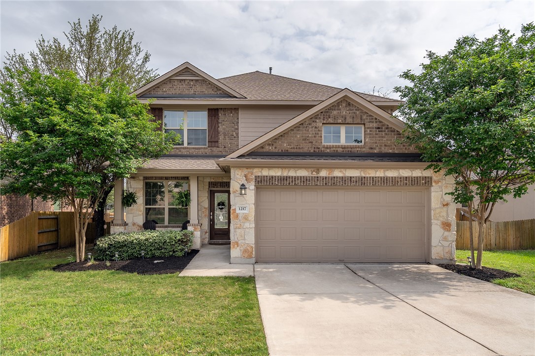 1217 Naranjo Drive Georgetown, TX 78628 - Photo 1 of 1 a front view of a house with a yard and garage