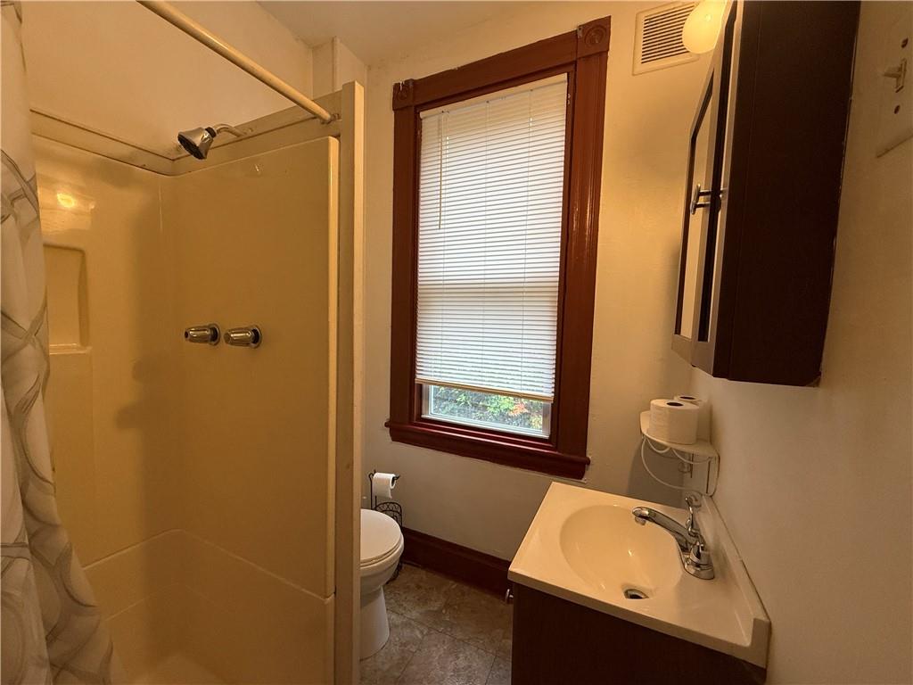 14 Shank Street Pittsburgh, PA 15212 - Photo 15 of 30 a bathroom with a sink a toilet and shower