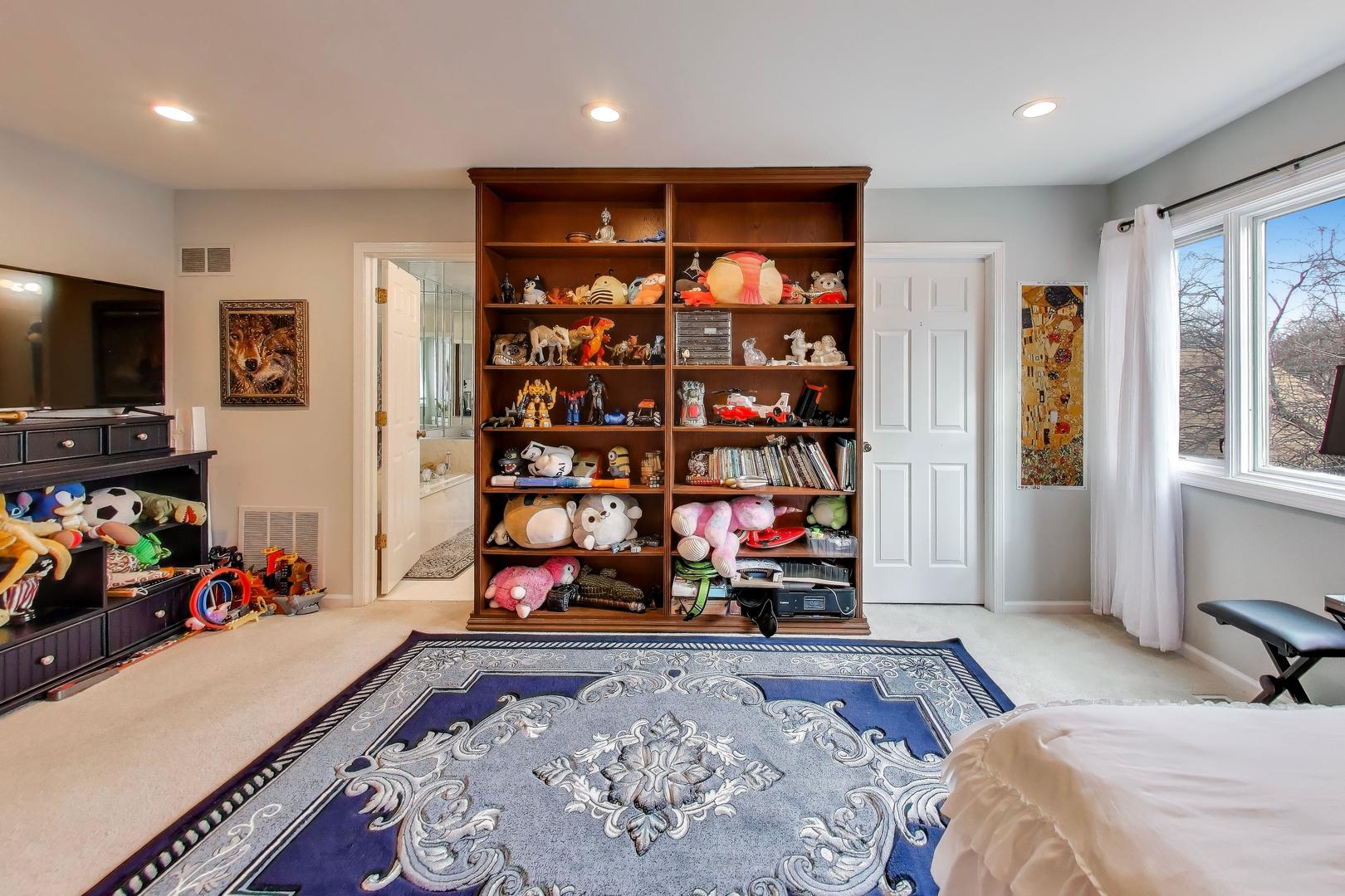 654 Picardy Circle Northbrook, IL 60062 - Photo 13 of 26 a bedroom with bed furniture and a flat screen tv