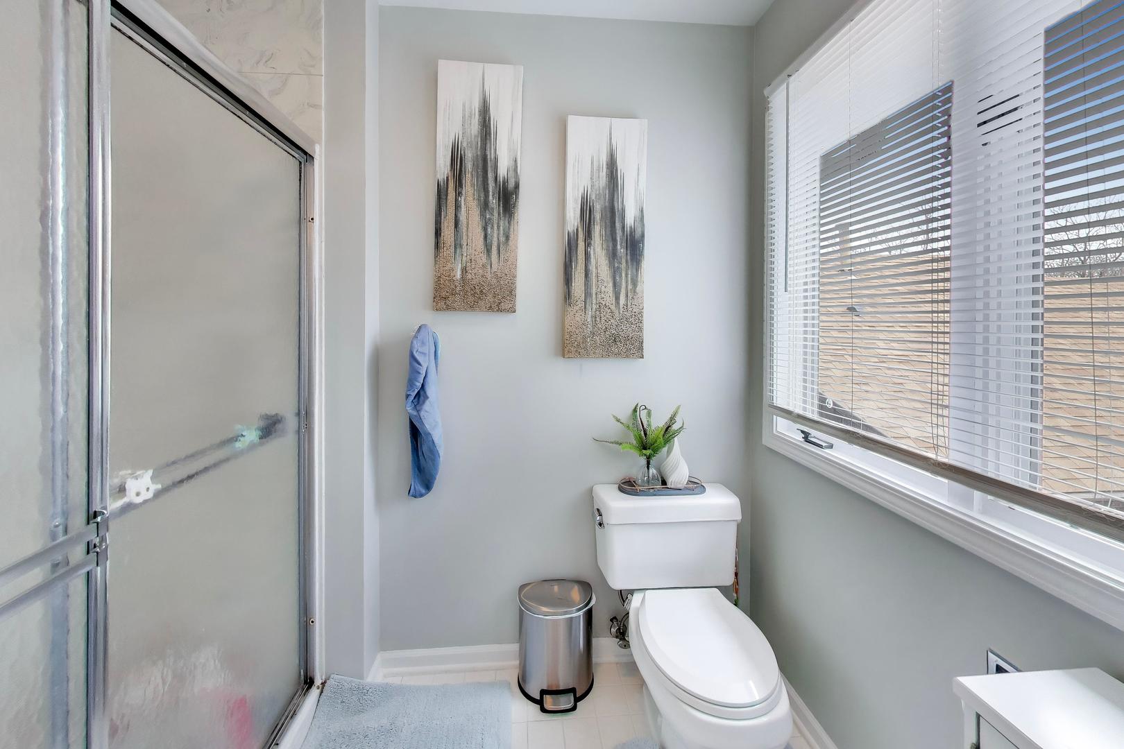 654 Picardy Circle Northbrook, IL 60062 - Photo 20 of 26 a white toilet sitting next to a bathroom sink