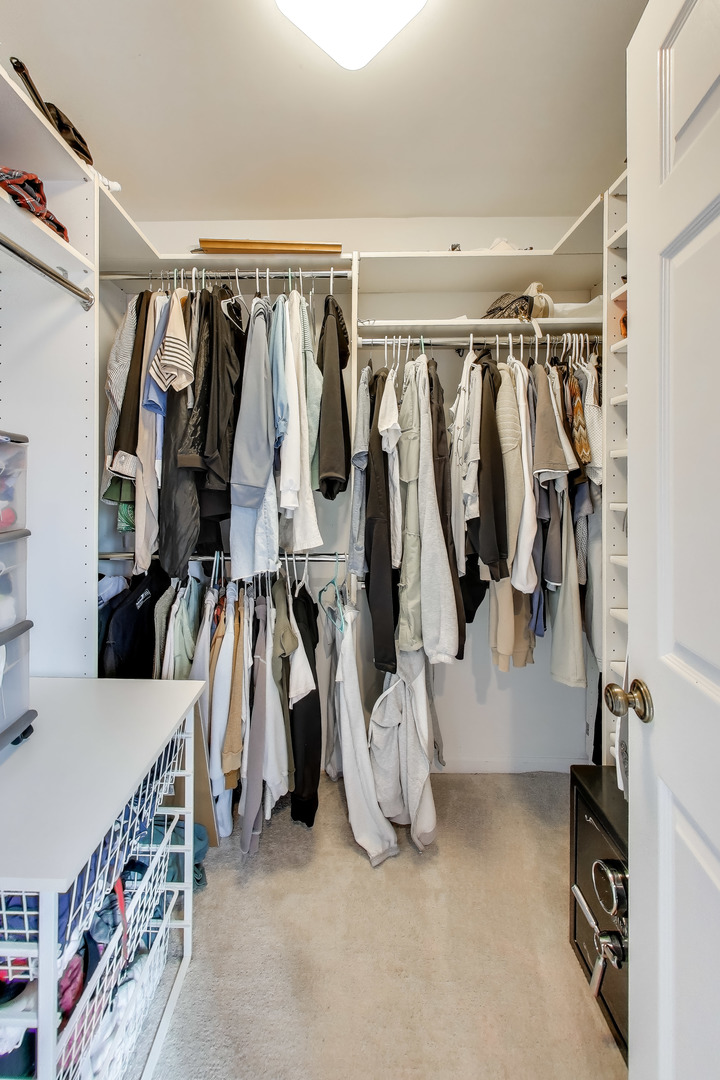 654 Picardy Circle Northbrook, IL 60062 - Photo 22 of 26 a view of walk in closet with clothes and shoes
