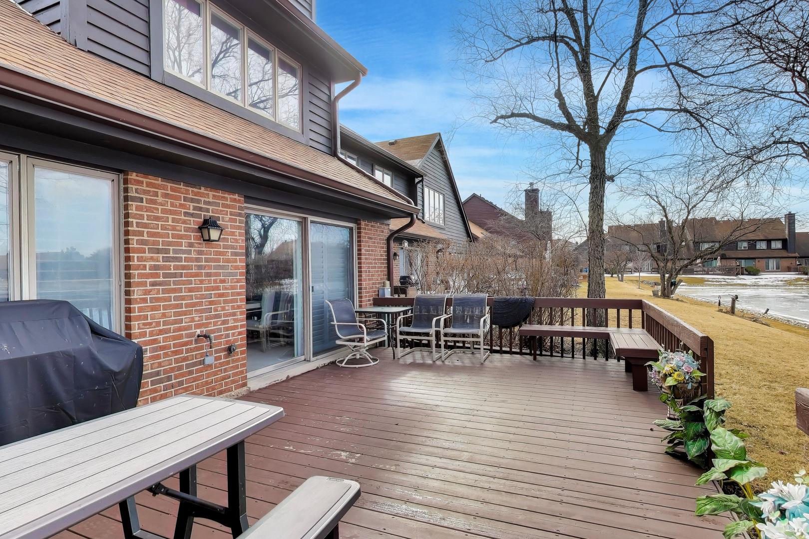 654 Picardy Circle Northbrook, IL 60062 - Photo 24 of 26 a view of a patio with table and chairs with wooden floor and fence