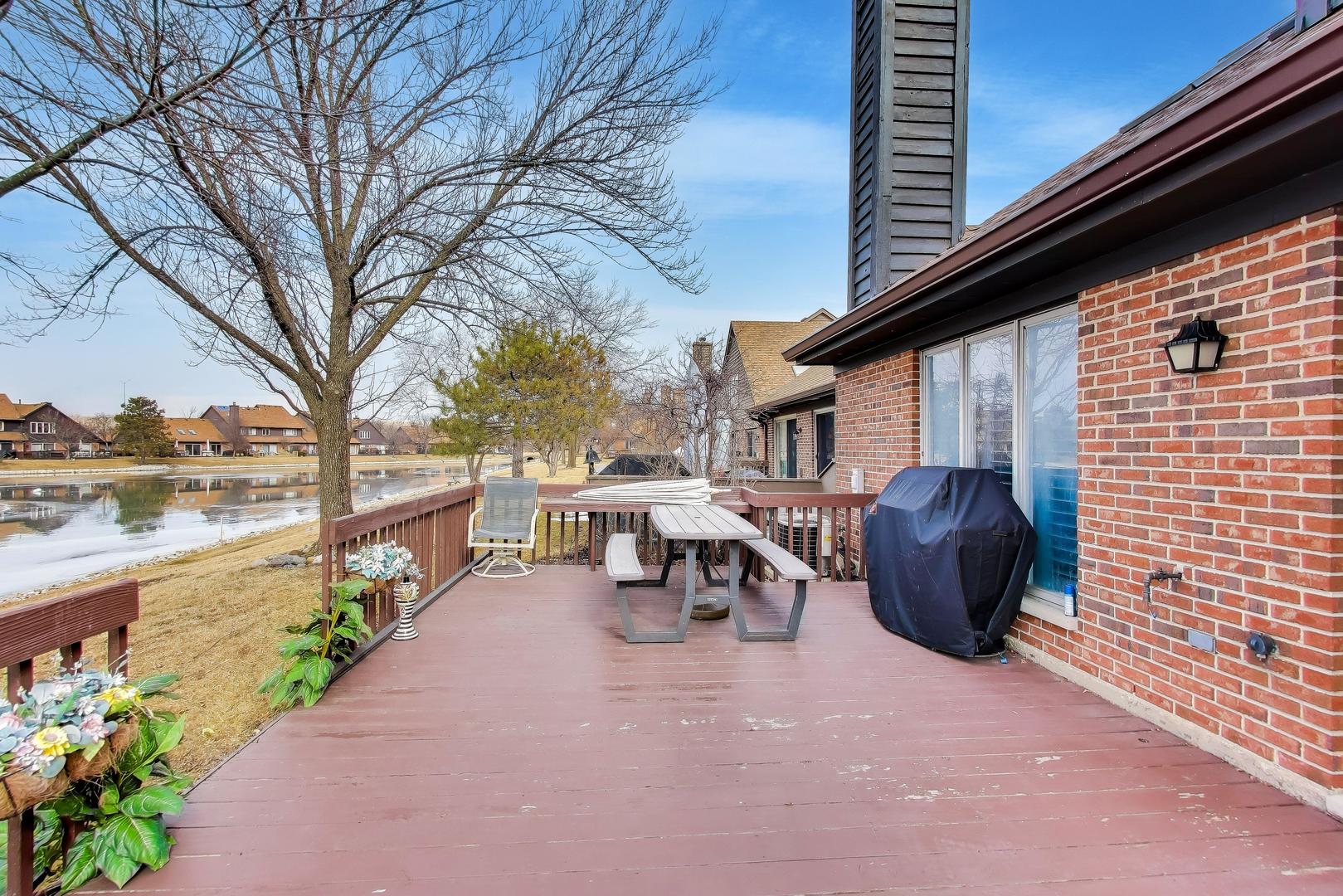 654 Picardy Circle Northbrook, IL 60062 - Photo 25 of 26 a view of a patio with a table chairs and a potted plant