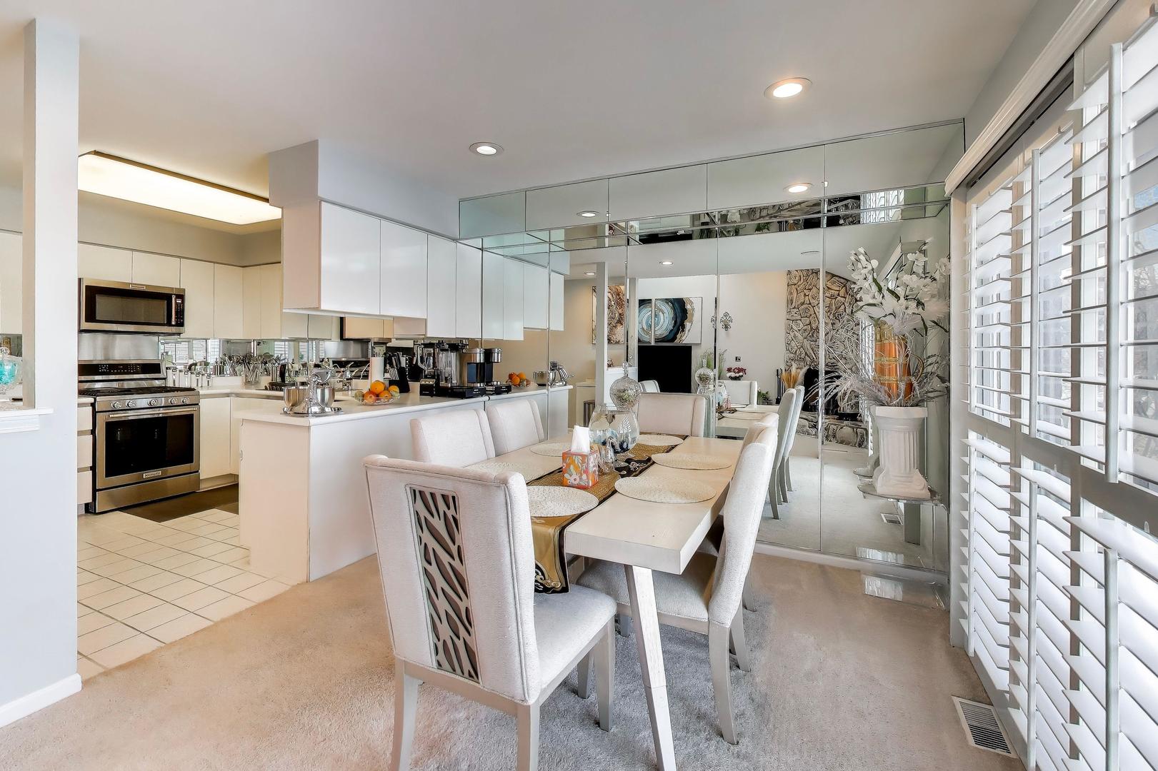 654 Picardy Circle Northbrook, IL 60062 - Photo 5 of 26 a dining room with stainless steel appliances kitchen island granite countertop a table chairs and a refrigerator