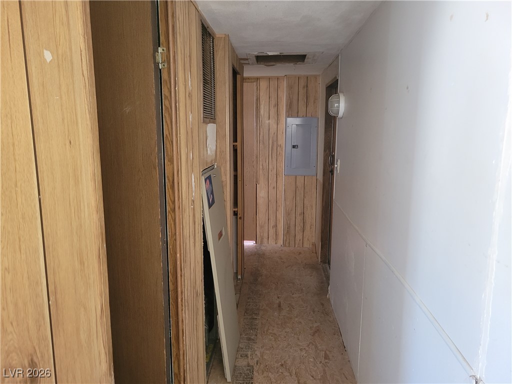 7950 South Wildhorse Road Pahrump, NV 89061 - Photo 22 of 28 Hallway featuring electric panel and wood walls