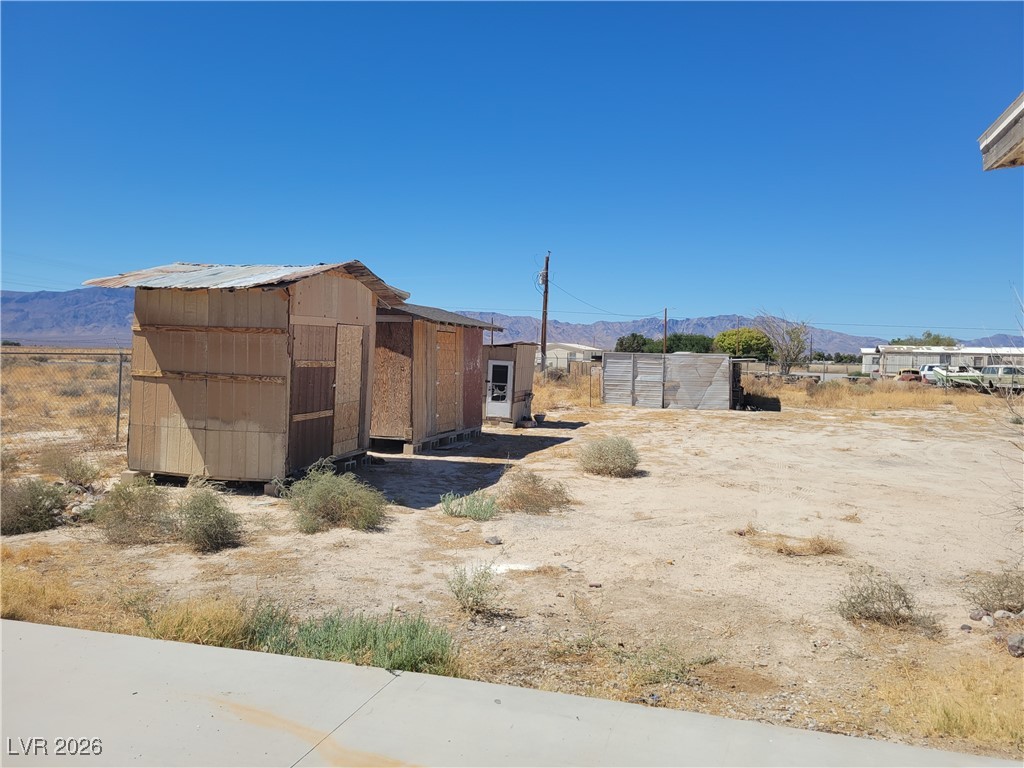 7950 South Wildhorse Road Pahrump, NV 89061 - Photo 3 of 28 View of yard featuring a mountain view