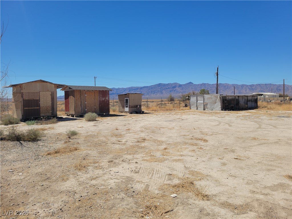 7950 South Wildhorse Road Pahrump, NV 89061 - Photo 4 of 28 View of yard featuring a shed, a view of countryside, and a mountain view