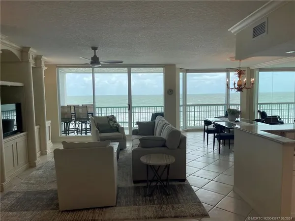 a living room with furniture and a floor to ceiling window