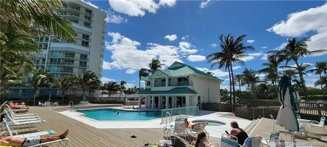 a view of a house with swimming pool and porch