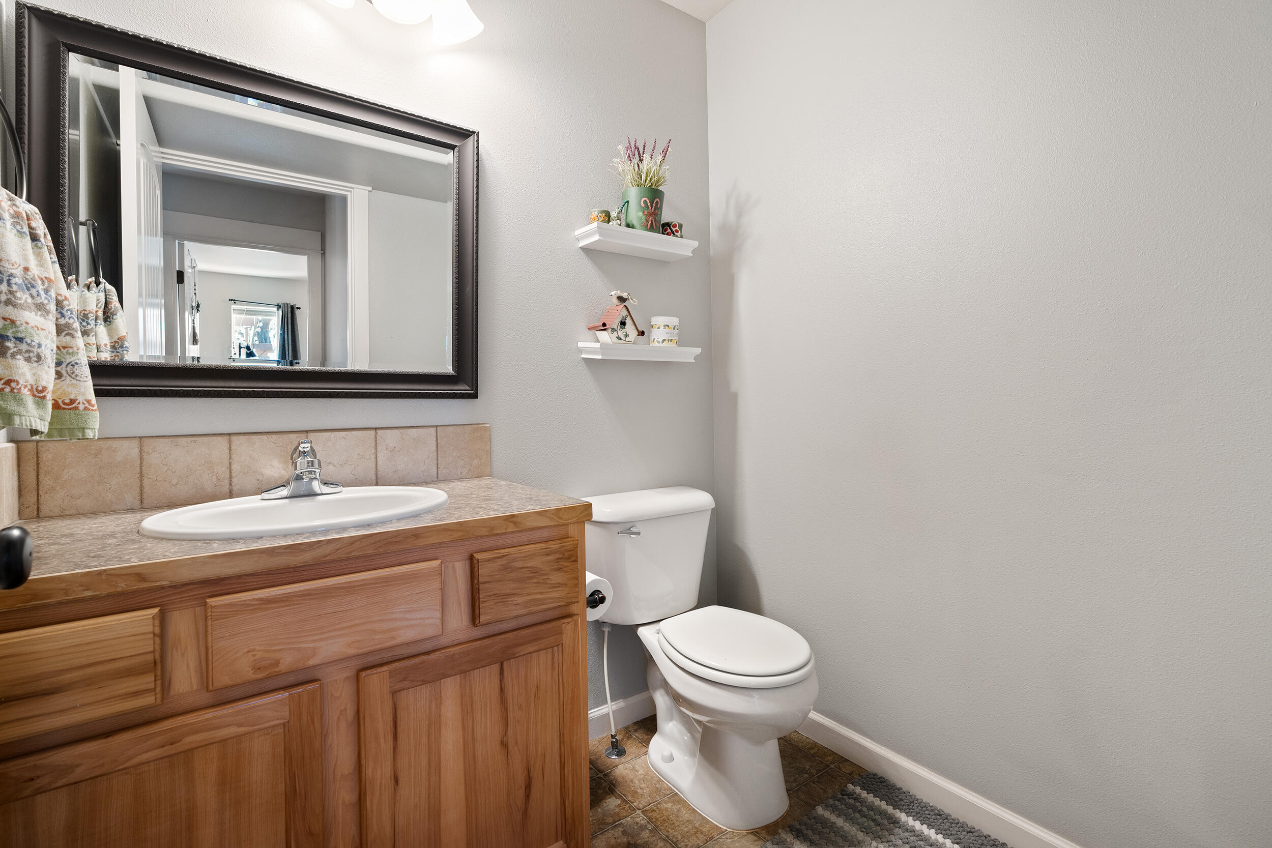 62906 Bilyeu Way Bend, OR 97701 - Photo 77 of 100 a bathroom with a toilet a sink and mirror